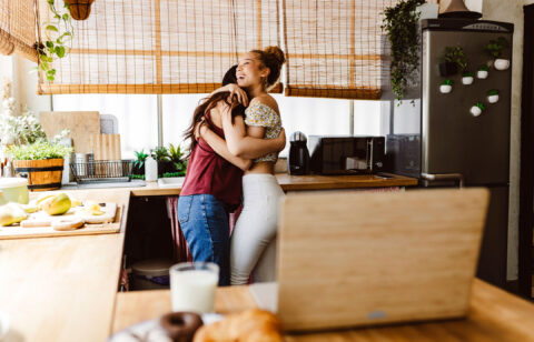 two-young-women-lesbian-gay-hugging-kitchen-home-2026-01-08-02-40-42-utc